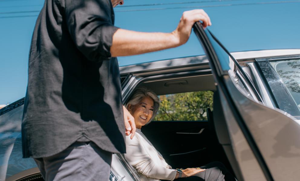Man assisting women in car