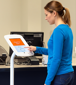 Woman at check in kiosk at a health center